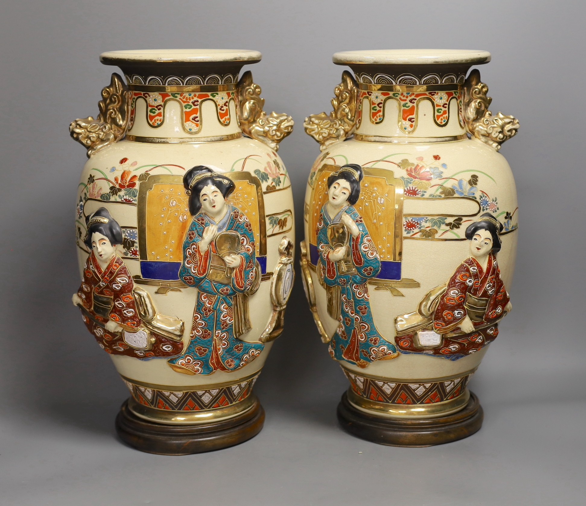 A pair of large Satsuma vases with relief decoration and dragon handles, 35cm tall with bases